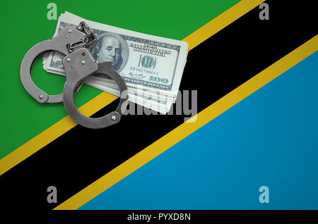 Tanzania bandera con esposas y un paquete de dólares. El concepto de quebrantar la ley y ladrones crímenes. Foto de stock