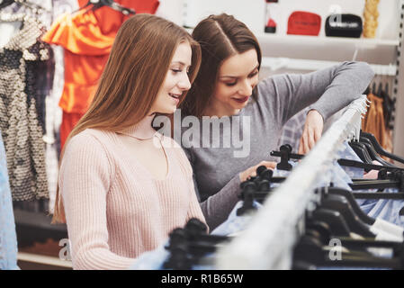Hermosas mujeres jóvenes en el mercado de telas semanal - Mejores amigos compartiendo el tiempo libre diversión y compras Foto de stock