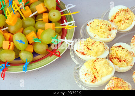 Deviled huevos con uva verde y queso cheddar aperitivo en mesa