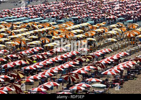 Sombrillas y reposeras para tomar sol, el turismo de masas en la playa de Caorle, Mar Adriático, Italia, Europa Foto de stock