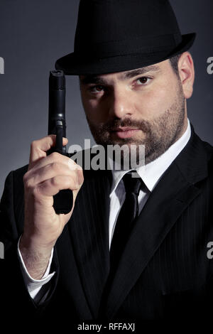 Hombre peligroso en traje con una pistola Foto de stock