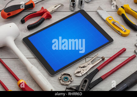Las herramientas de la casa y tablet con pantalla de cuadrícula concepto