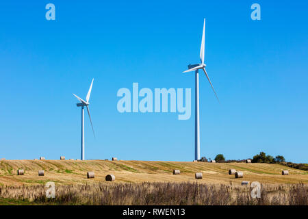Balas de heno y turbinas eólicas, West Cape, Prince Edward Island, Canadá Foto de stock