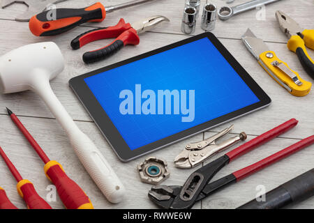 Las herramientas de la casa y tablet con pantalla de cuadrícula concepto