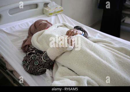 Sanaa, Yemen. 12 Mar, 2019. Una mujer yemenita recibe tratamiento de heridas sufridas durante un ataque aéreo informó en un hospital. Según la ONU, un periodo de 48 horas las huelgas mató a 22 personas, incluyendo una docena de niños, a principios de esta semana. Crédito: Hani Al-Ansi/dpa/Alamy Live News Foto de stock