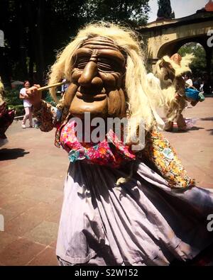 Una mujer enmascarada lleva a cabo la danza de los ancianos (Danza de los viejitos) en Coyoacán, México Foto de stock