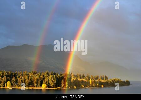 Hermoso brillante verdadero doble arco iris en el cielo nublado, Queenstown, Nueva Zelanda Foto de stock