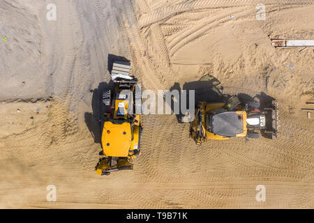 Carretilla Industrial excavadora cargador moviendo la tierra y descarga. Vista aérea Foto de stock