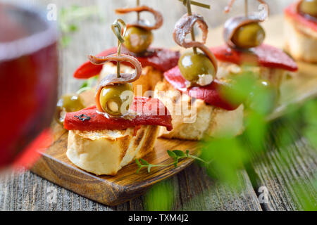 Español: pinchos pincho bocadillos hechos de pan tostado con asado y pimientos en escabeche, aceitunas rellenas y encima filetes de anchoa