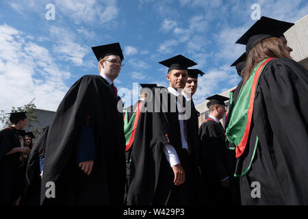 La educación superior en el REINO UNIDO - alumnos exitosos en la ceremonia de graduación de la universidad de Aberystwyth, después de recibir sus grados, vistiendo sus tradicionales tapas y batas. Julio de 2019