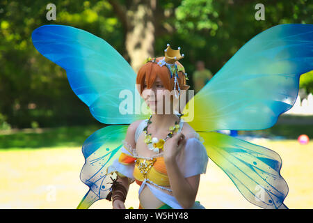 Hannover, Alemania, 30 de junio, 2019: Yong cosplayer femenino posa durante el alemán-japoneses festival en parque público, personaje de manga de una mariposa con blu Foto de stock