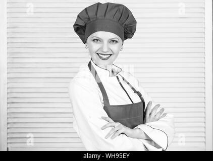 Chef mujer en delantal con utensilios de cocina aislado sobre