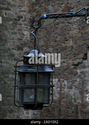Ancienne lanterne en fer forgé patiné sur un mur de pierre de l'antique château Burg ('Schloss Burg') hangig en cage de fer Banque D'Images