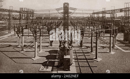 La dernière version de l'ingénierie et de la technologie des années 1930 : Le réseau de pylônes et de lignes aériennes dans un poste de transformation grille britannique, une partie du réseau électrique. Banque D'Images