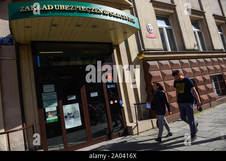 Les gens devant une institution d'assurance sociale (ZUS) au centre-ville de Cracovie.Le gouvernement au pouvoir, du parti Droit et Justice a annoncé plusieurs nouveaux forfaits bien-être social à l'approche des élections législatives, a le "500 +" du programme de l'enfant à l'ensemble des enfants, une prime pour les retraités qui exclut les travailleurs de moins de 26 d'impôt entre autres. Banque D'Images