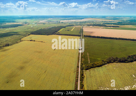 La route à travers champs arables et beau ciel pittoresque. Vue de dessus de la campagne et l'autoroute. Paysage rural de l'été sur une journée ensoleillée Banque D'Images
