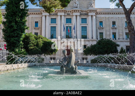 Vue avant de la fontaine par G. Di Prinzio, sculpture en bronze d'une femme montant un cheval. Bureaux du gouvernement (province de Pescara, Italie) en arrière-plan. Banque D'Images