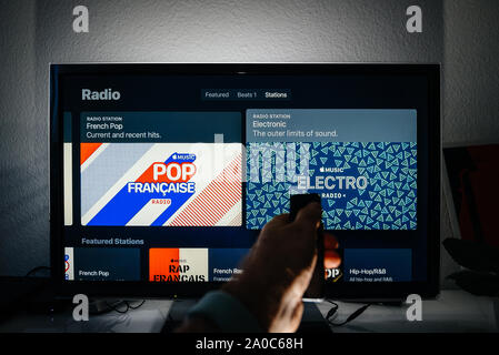 Paris, France - Circa 2019 : Apple menu TV plasma Panasonic sur salon avec télévision top 100 classements Tracer maintenant et d'une station de radio française et la radio électronique hits playlist par Apple Musique Banque D'Images