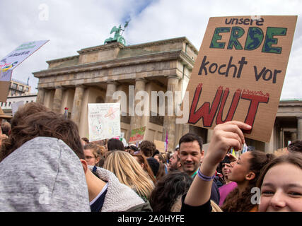 Berlin, Allemagne. Sep 20, 2019. Les participants se réunissent pour une manifestation en face de la porte de Brandebourg. Un participant est titulaire d'une affiche avec l'inscription "notre terre est à l'ébullition avec rage'. Les manifestants suivent l'appel du mouvement vendredi pour l'avenir et veulent se battre pour plus de la protection du climat. Ils veulent appuyer les appels à des grèves et des manifestations dans le monde entier. Credit : Jens Büttner/dpa-Zentralbild/dpa/Alamy Live News Banque D'Images