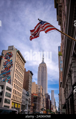 New York, USA - Erii 31 Août 2019 : l'Empire State Building et les édifices dans le centre de Manhattan avec les USA flag on top Banque D'Images