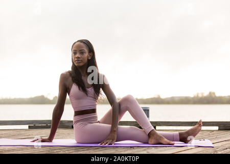 Tara faire tôt le matin le yoga à l'extérieur un jour d'été Banque D'Images