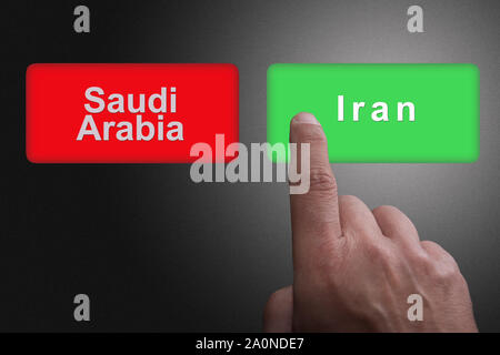 Boutons avec écrit l'Arabie Saoudite et l'Iran et en pointant du doigt, sur un fond de dégradé de gris : Concept d'avoir choisi l'Iran Banque D'Images