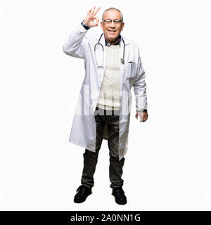 Beau médecin senior man wearing medical coat smiling faire positif ok signe avec la main et des doigts. Expression réussie. Banque D'Images