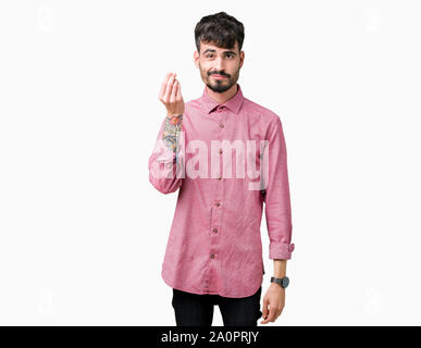 Beau jeune homme portant chemise rose sur fond isolé italien faisant geste avec la main et des doigts expression confiante Banque D'Images