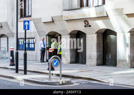 Trois membres du personnel à discuter à l'entrée de la Cour Criminelle Centrale, ou Old Bailey, London, UK Banque D'Images