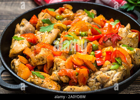 Sauté de poulet aux légumes sur table en bois. Banque D'Images