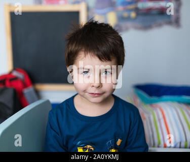 Portrait of a smiling, joli garçon de plusieurs années dans la chambre des enfants. Banque D'Images