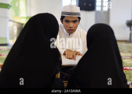 Une formation à l'enseignement des jeunes Malais religion 2 femmes enfants à l'intérieur de la Mosquée Sultan Masjid, Singapour Banque D'Images