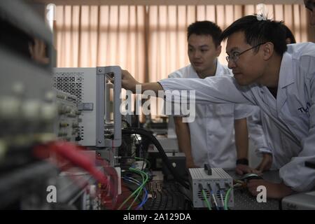 (190923) -- Chengdu, 23 septembre 2019 (Xinhua) -- professeur associé Fu Wenjie (R) de l'Université des Sciences et Technologies de Chine (UESTC) tests et débogue le jet de plasma avec l'analyseur de réseau vectoriel dans l'UESTC à Chengdu, dans le sud-ouest de la province chinoise du Sichuan, le 19 septembre 2019. Récemment, des chercheurs du département de physique et d'électronique, de l'école des sciences et de l'ingénierie électronique à l'UESTC ont développé avec succès un nouvel ordinateur de poche jet plasma après deux ans d'expériences scientifiques. Plasma sont excités par l'énergie des micro-ondes. Par la conception d'une structure particulière pour t Banque D'Images