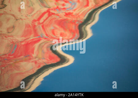 Reflets dans l'eau de la peinture d'un vieux bateau dans le port de Brixham, Devon, Angleterre Royaume-uni GB Banque D'Images