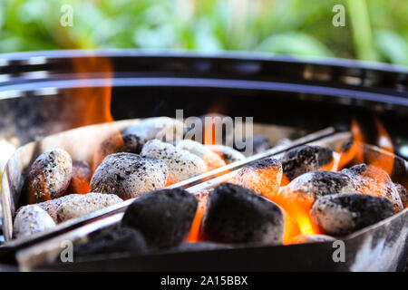 Barbecue électrique chargé avec flaming rougeoyant et briquettes de charbon de bois chaud, prêt pour la nourriture d'être mis en et cuits. Banque D'Images