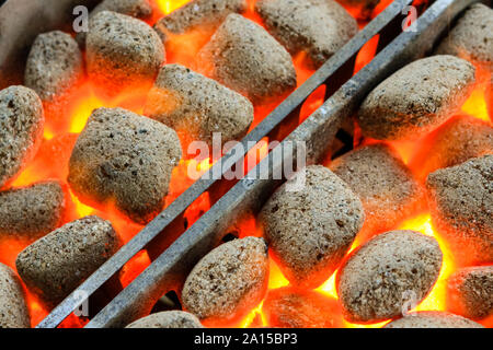 Barbecue électrique chargé avec flaming rougeoyant et briquettes de charbon de bois chaud, prêt pour la nourriture d'être mis en et cuits. Banque D'Images