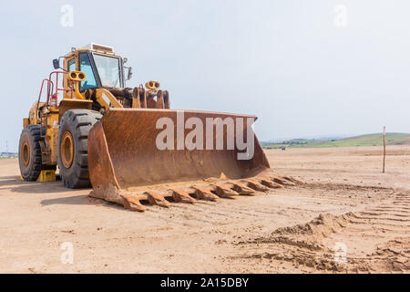 Benne chargeuse industrielle écope de la benne véhicule stationné sur la propriété industrielle nouvelle plate-forme de développement construction terrassement dans countrysidse Banque D'Images