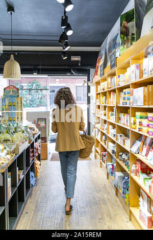 Jeune femme shopping dans un magasin d'alimentation Banque D'Images