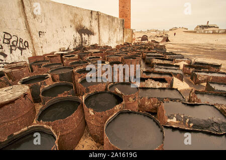 Vieux barils d'huile au village abandonné d'Ilha dos Tigres, Angola Banque D'Images