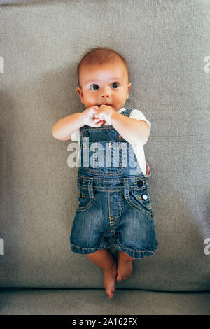 Baby Boy sitting on a sofa Banque D'Images