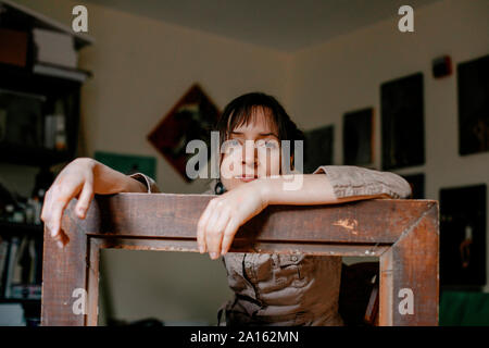 Portrait d'une femme peintre dans son atelier s'appuyant sur photo frame Banque D'Images