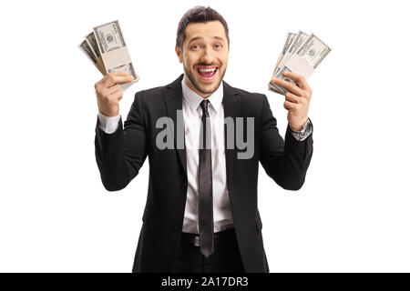 L'homme excité dans un costume noir tenant des piles de l'argent dans les deux mains isolé sur fond blanc Banque D'Images