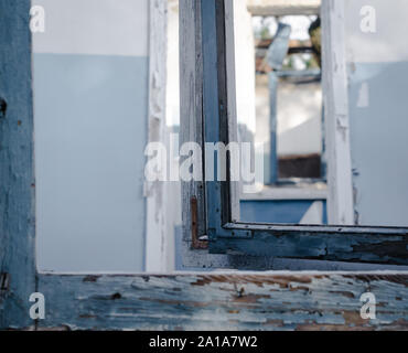 Vue de la fenêtre sur les murs, fenêtres, portes d'une maison abandonnée Banque D'Images