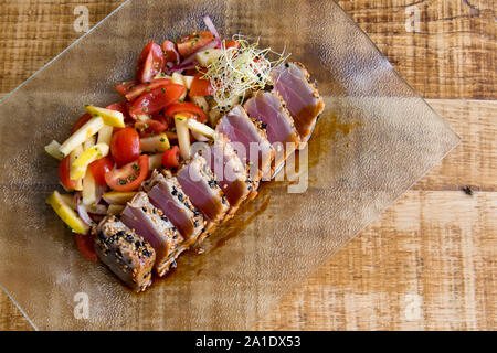 Tataki de thon fraîchement cuit tataki (de atún) servi sur une plaque d'retangular claire. Banque D'Images