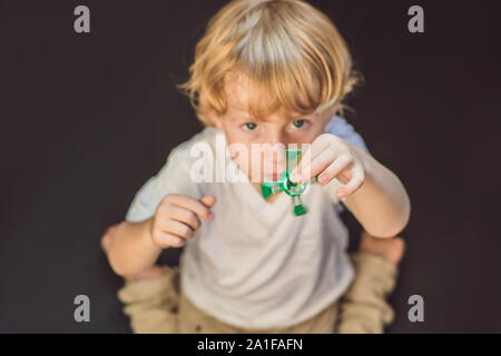 Jeune garçon jouer avec fidget spinner, le jouet. Banque D'Images