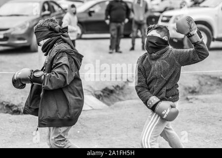 Fête des mineurs au village d'El Volcan, vallée de Cajon del Maipo, dans les Andes. Combat de boxe aveugle pour les enfants, un événement amusant pendant la fête Banque D'Images