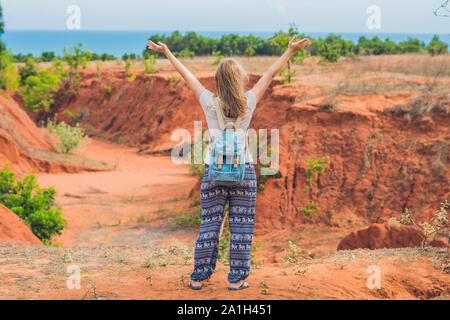 Jeune femme en rouge canyon près de Mui Ne, le sud du Vietnam. Banque D'Images