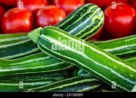 Rayé vert avec courgettes tomates mûres dans l'arrière-plan Banque D'Images