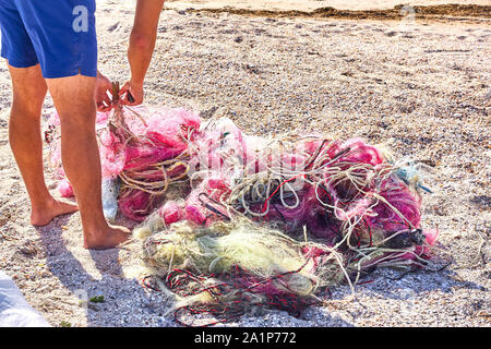 Un gâchis de filets de pêche corde en plastique et d'autres débris échoués sur une plage côtière. Sauver la planète stock photo. Banque D'Images