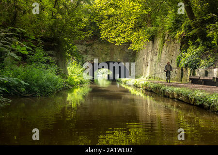 Un homme sur un chemin de halage le long des cycles de l'du canal de Shropshire Union en Angleterre. Banque D'Images